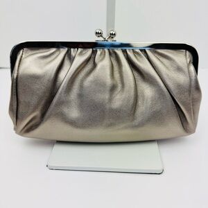 Express Vintage metallic silver-tone leather clutch,  chrome kiss snap closure.